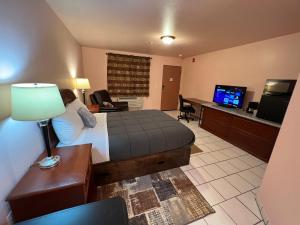 Frazier ParkFrazier View Motel的酒店客房配有一张床、一张书桌和一台电视。