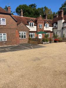 彼得斯菲尔德The Old Dairy Steep,Petersfield in Collyers Estate in the South Downs National park的前面有车道的大型砖屋