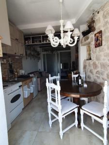 布德瓦Stone house Djakonovic的厨房配有桌子、两把椅子和吊灯。