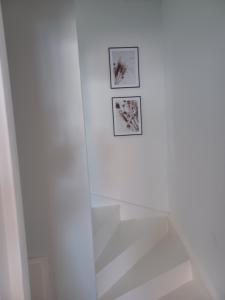 Luxe-kamer Bed en Bokes的墙上有两张照片的白色淋浴