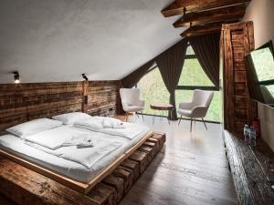 什切尔克Poczuj Spokój Szczyrk - Free Sauna & Balia的一间卧室配有一张大床和两把椅子