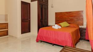 科巴Hotel Nojoch che的一间卧室配有一张床和一个木制床头板