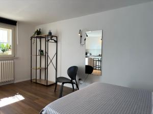 马泰拉Residenza 1930的一间卧室配有一张床、一把椅子和镜子
