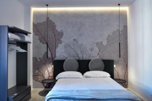 卡塔尼亚Dadà Suites的一间卧室设有一张大床和一面墙