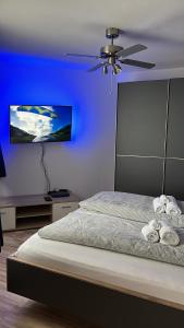 汉诺威Ferienwohnung Artemis的蓝色卧室配有一张带吊扇的床