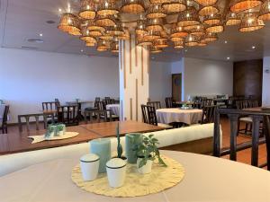 丰沙尔大金塔德弗兰卡酒店的一间带桌椅和吊灯的用餐室