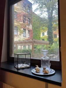 马尔默露丝拉格纳旅馆的窗户台,上面有一盘糕点和玻璃瓶