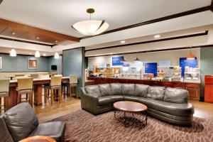 比尤特布特智选假日酒店的客厅设有真皮沙发和酒吧。