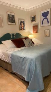 圣安尼Celadon guadeloupe的卧室配有一张床铺,卧室墙上挂有照片