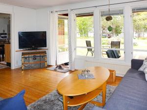 门斯特罗斯Holiday home Mönsterås VII的客厅配有桌子和电视