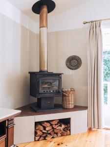 谭伯连山Romantic Cottage, Tamborine Mountain的厨房里放有一堆木头的炉灶