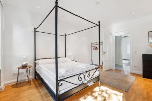 柏林Bright 3-room apartment near Prenzlauer Berg的一间卧室配有一张黑色天蓬床。