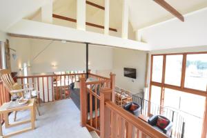 Campsey AshQuill Farm Barn, Campsea Ashe的客厅设有木制楼梯和窗户。