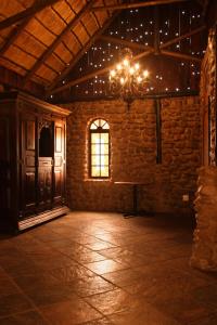 uMhlaliRain Farm Game Lodge的一个空房间,有一个吊灯和一个窗口