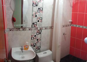 伊察LUANA’S HOUSE的一间带卫生间、水槽和镜子的浴室