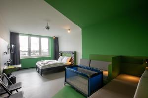 德累斯顿MEININGER Hotel Dresden Zentrum的绿色的客房配有床和沙发