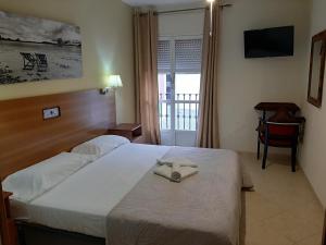 普韦布洛·纽沃·德·加德Sotel Valle Guadiaro的一间酒店客房,配有一张带毛巾的床