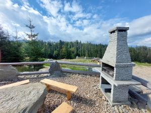 扎科帕内Tatrzanska Polana - Mountain View, Free Parking & WiFi的石头壁炉、长凳和野餐桌