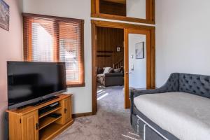马姆莫斯湖Mountainback 19的客厅配有平面电视和1张床。