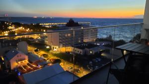 米兹多洛杰Komfortable strandnahe Ferienwohnung A103 in 10 Etage mit Terrasse und Meerblick PARKING FREE的阳台享有夜间城市美景。