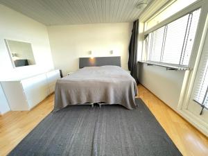 雷克雅未克Cosy and spacious apartment in Reykjavik的一间卧室设有一张床和一个大窗户