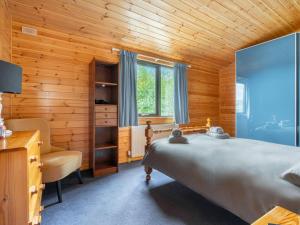 金罗斯Chalet Lodge 9 by Interhome的一间卧室配有一张床、一张桌子和一把椅子