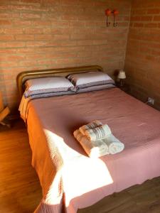 圣本图-杜萨普卡伊Casa Baúau的房间里的一张床位,上面有两条毛巾