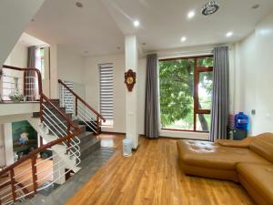 清化Mint Homestay - Thanh Hóa的带沙发和楼梯的客厅