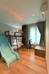清迈Moose Hotel Nimman的一间带滑梯的卧室和一间带双层床的房间