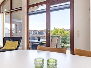 博恩瑟4 person holiday home in Bogense的客房设有桌椅和大窗户。
