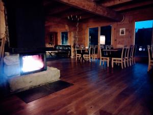 米卢夫卡Villa Beskid的客厅设有壁炉、桌子和椅子
