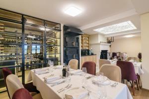 Sladka VodaCarpe Diem的一间带白色桌椅的餐厅和一个酒窖