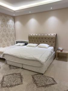 SuḩaybahThe Fort Farm的卧室配有一张白色大床和床头板