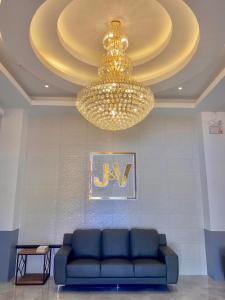 ApalengJ&V Hotel and Resort的客厅配有蓝色的沙发和吊灯。