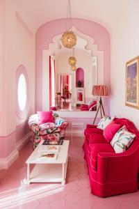 圣安格塔苏德格尔夫顿阿尔丰索1890精品酒店的客厅配有两张红色的沙发和一张桌子