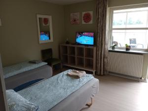 福旺Annex88 B&B的一间卧室设有两张床、一台电视和一扇窗户。