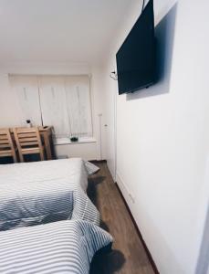 乌斯怀亚Ulen的一间卧室设有两张床,墙上配有电视。