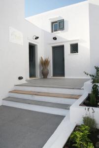 Livadi Astypalaias5 Traditional Suites的前面有楼梯的白色房子