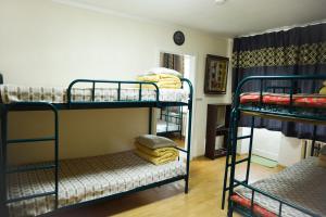 乌兰巴托UB Guesthouse & Tours的一间设有三张双层床的房间和一间设有