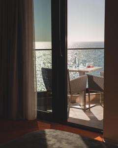 多布拉沃达Kalamper Hotel & Spa的透过门可欣赏到海景的客房