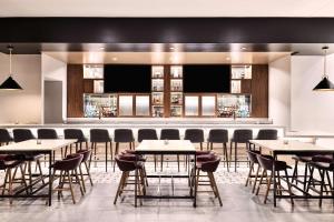 凤凰城Hyatt Place Phoenix/Downtown的一间带桌椅的餐厅和一间酒吧