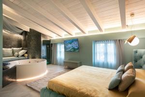 里沃托托Il Giardino degli Angeli的一间卧室设有一张大床和一个浴缸
