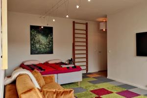 坦佩雷Lovely 7th floor studio full of color, enjoy!的一间卧室配有一张带梯子的床和一台电视