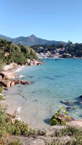 塞尔苏拉穆斯州长镇Pousada Casa do Oscar的一片蔚蓝的海滩和一个以城镇为背景的城镇