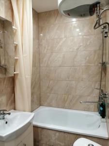 利耶帕亚Apartamenti Miera Osta的浴室配有白色浴缸和水槽