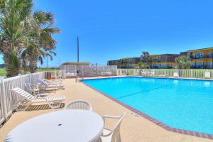 阿兰瑟斯港Unit 32, Island Retreat Resort的游泳池配有椅子、桌子和桌椅