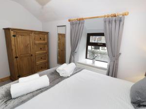 布莱奈费斯蒂尼奥格Bridgeway House的卧室配有白色的床和窗户。