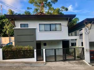 达沃市Modern House w/Great Location Nr SM & Jack’s Ridge的白色的房子,有黑色的围栏