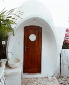 特鲁卡那拉特Villa Dreamdome的白色客房内的木门,带水槽
