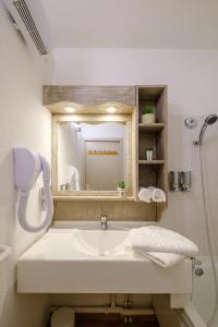 隆勒索涅温泉浴场公寓酒店的一间带水槽和镜子的浴室